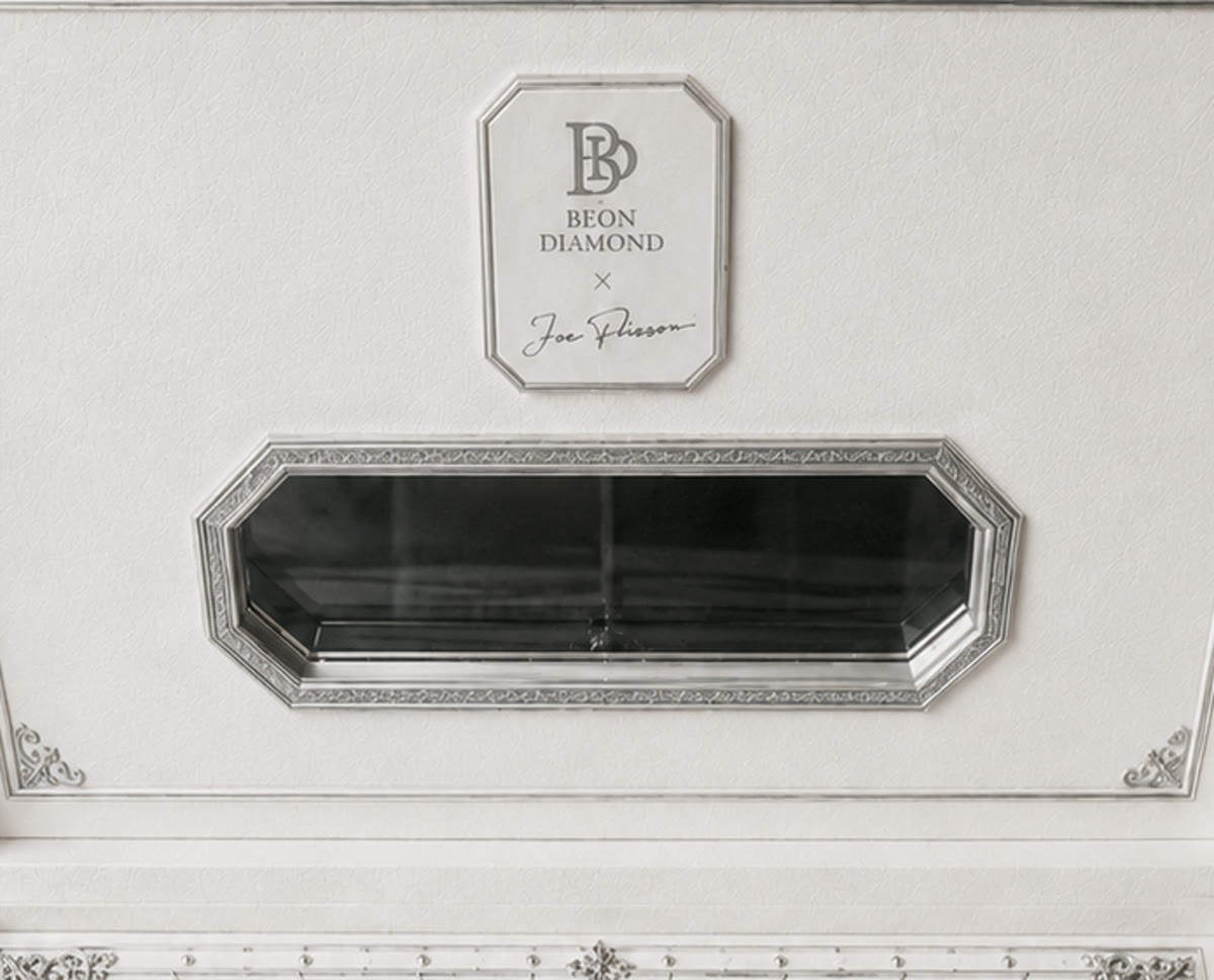 Tag A — octagonal tablet plaque with BD monogram over the Joe Flizzow signature